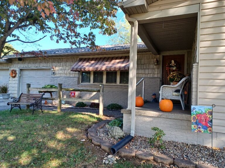 Coordinated striped awnings on a house and porch in southeastern Ohio
