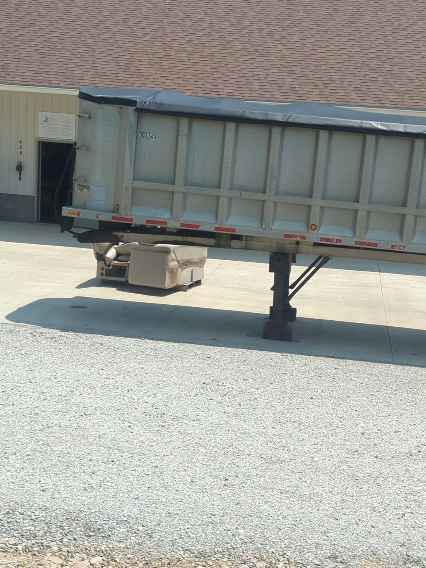 Gray tarp fitted over a dump trailer in southeastern Ohio