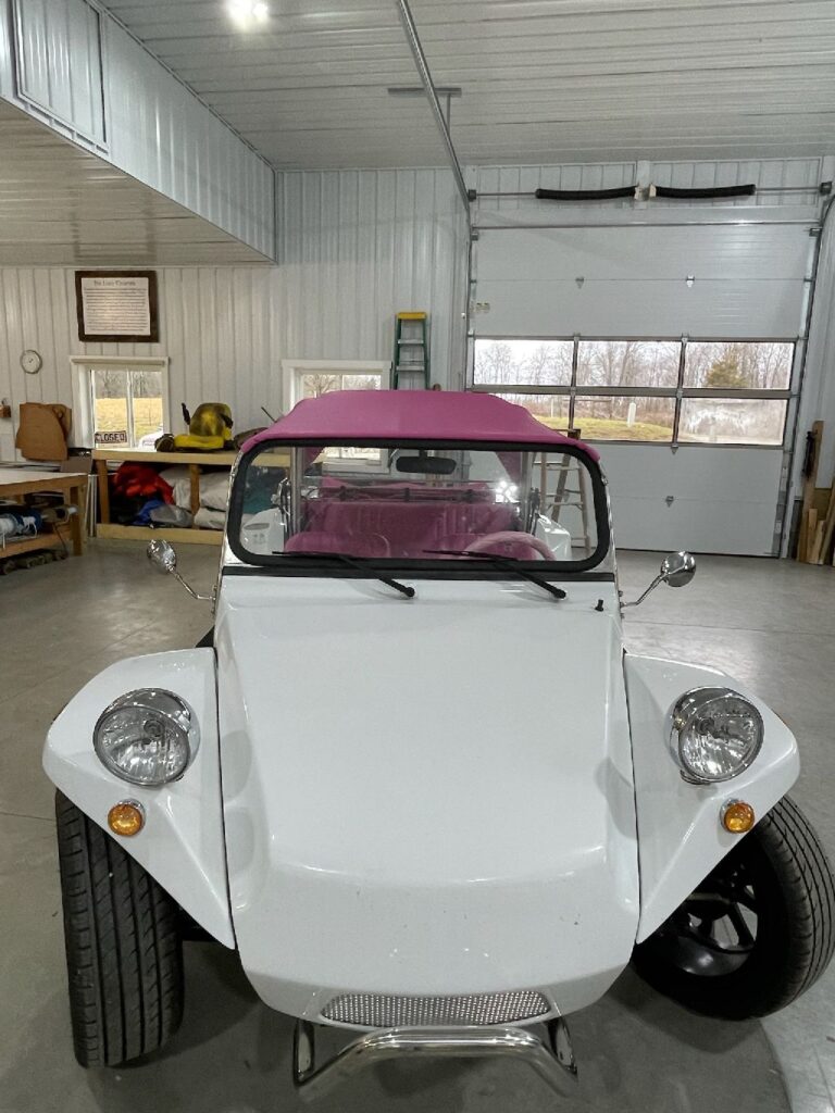 White dune buggy with a bright pink custom soft top in southeastern Ohio