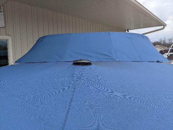Blue cover fitted around boat hardware in southeastern Ohio
