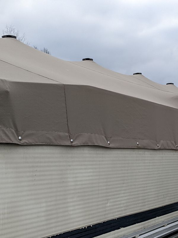 Tan custom cover fitted to a pontoon in southeastern Ohio