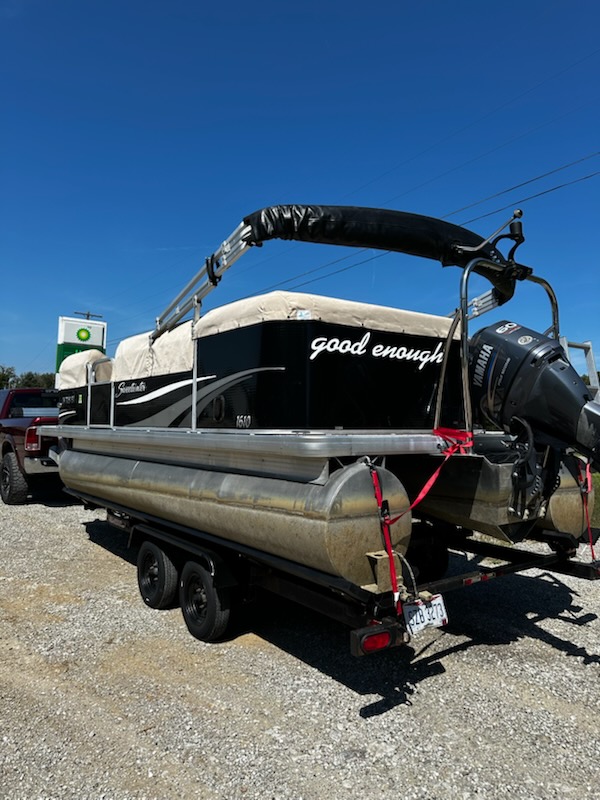 Pontoon boat with a custom bimini top by Erbco