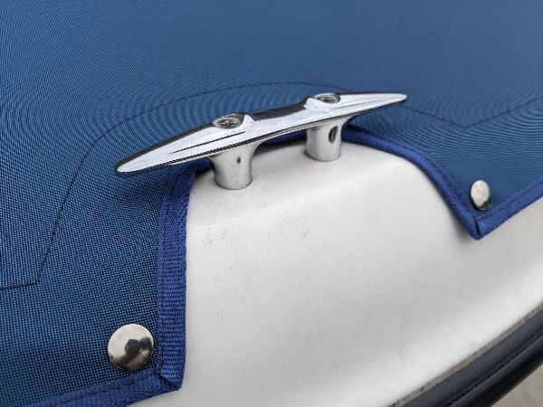 Cleat opening detail in a fitted blue boat cover in southeastern Ohio
