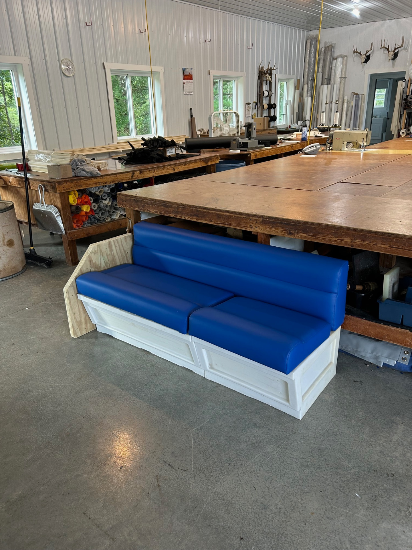 Newly upholstered blue pontoon bench in the Erbco workshop in southeastern Ohio