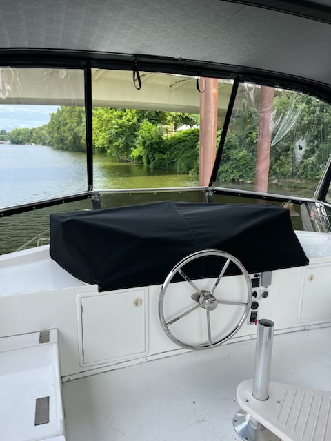 Black cockpit cover fitted over a boat helm in southeastern Ohio