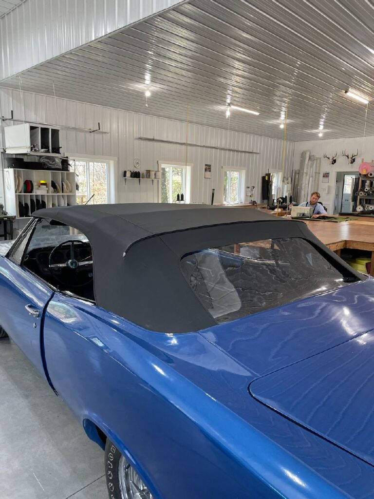 Blue classic car with a fitted dark convertible top in southeastern Ohio