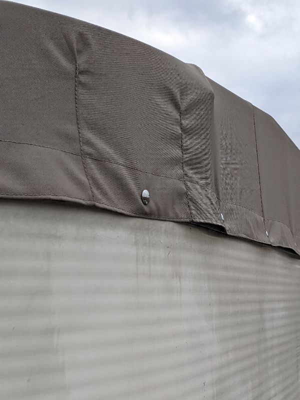 Fastening detail on a tan pontoon cover in southeastern Ohio