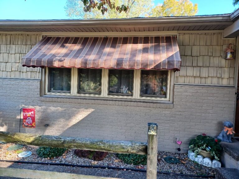 Striped fabric window awning on a home in southeastern Ohio