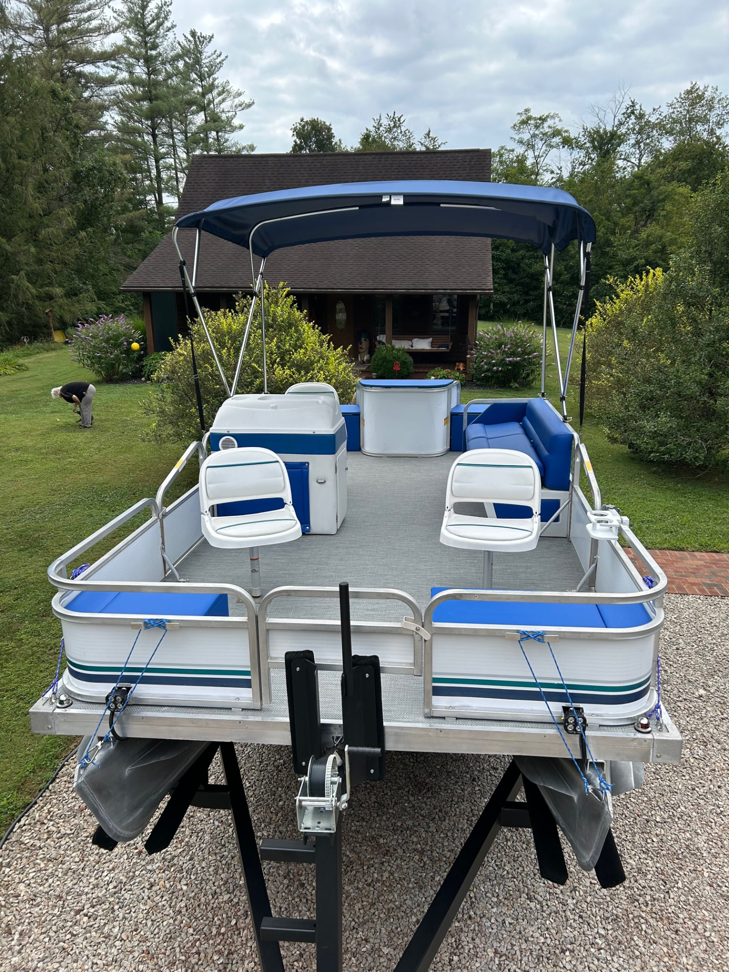 Blue and white pontoon seating, gray flooring, and navy canopy in southeastern Ohio