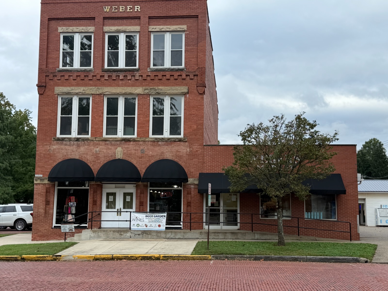 Black fixed awnings on a brick storefront