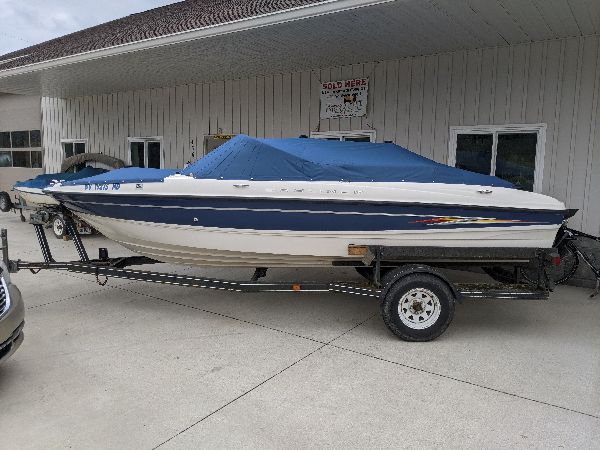 Runabout boat with a fitted blue custom cover by Erbco in Vincent, Ohio