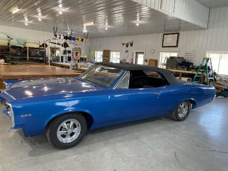 Blue classic car with a fitted dark convertible top by Erbco