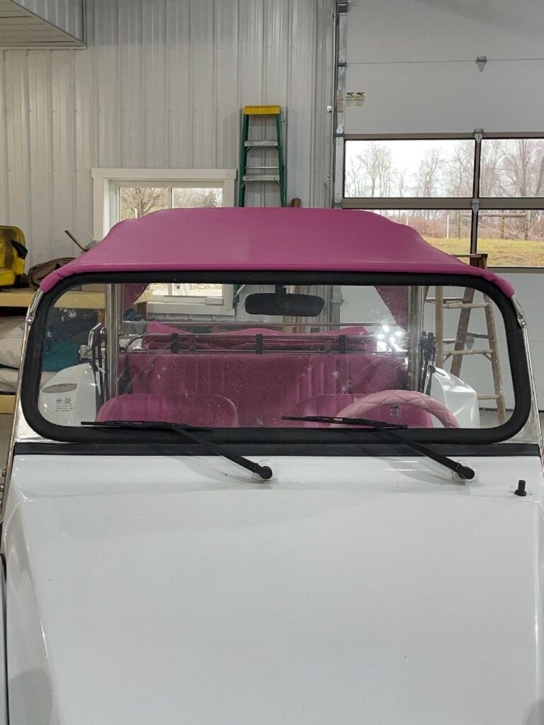 Pink soft top fitted around a dune buggy windshield in southeastern Ohio