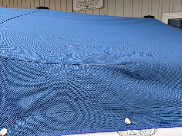 Reinforced stitching on a blue fitted boat cover in southeastern Ohio